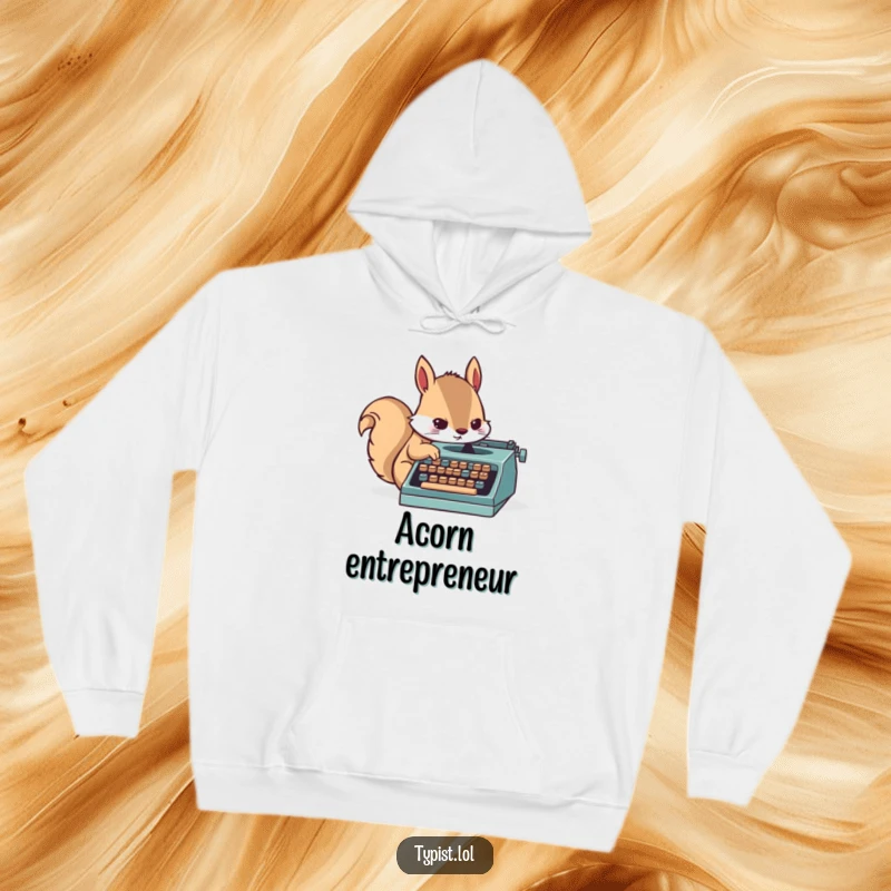 Funny hoodie design of a determined squirrel character typing furiously on a miniature typewriter, embodying creative hustle.