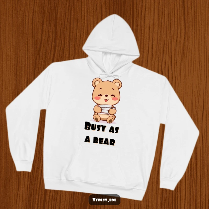 Funny Bear Hoodie: A smiling bear character happily holds a large stack of papers, offering cozy humor for work or relaxation.