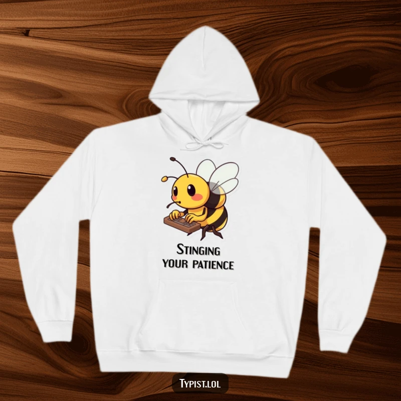 Funny bee hoodie showing a busy bee diligently typing on a keyboard with its tiny stinger, looking focused.