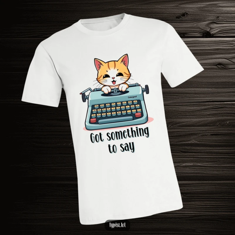 Funny cat author t-shirt, a determined cat typing furiously on a large typewriter with oversized keys.